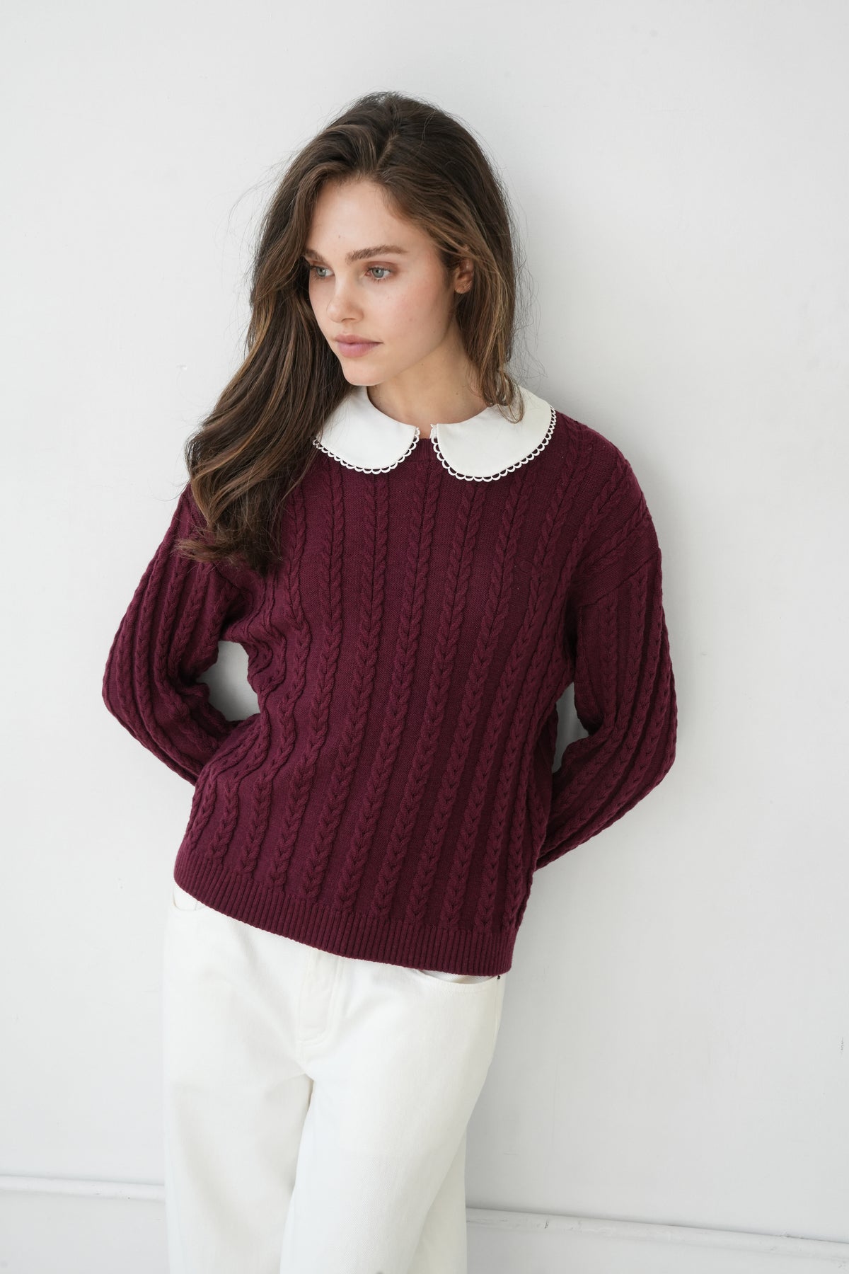 Girl wearing a red collared sweater.